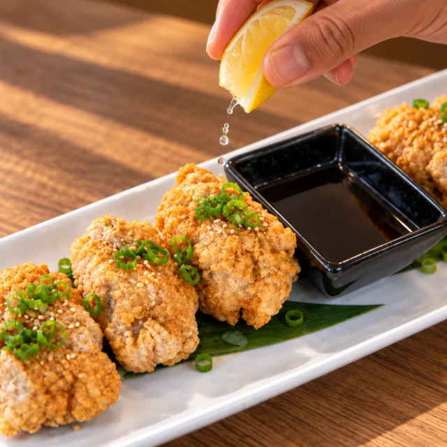 Lemon squeezed over crisp chicken karaage